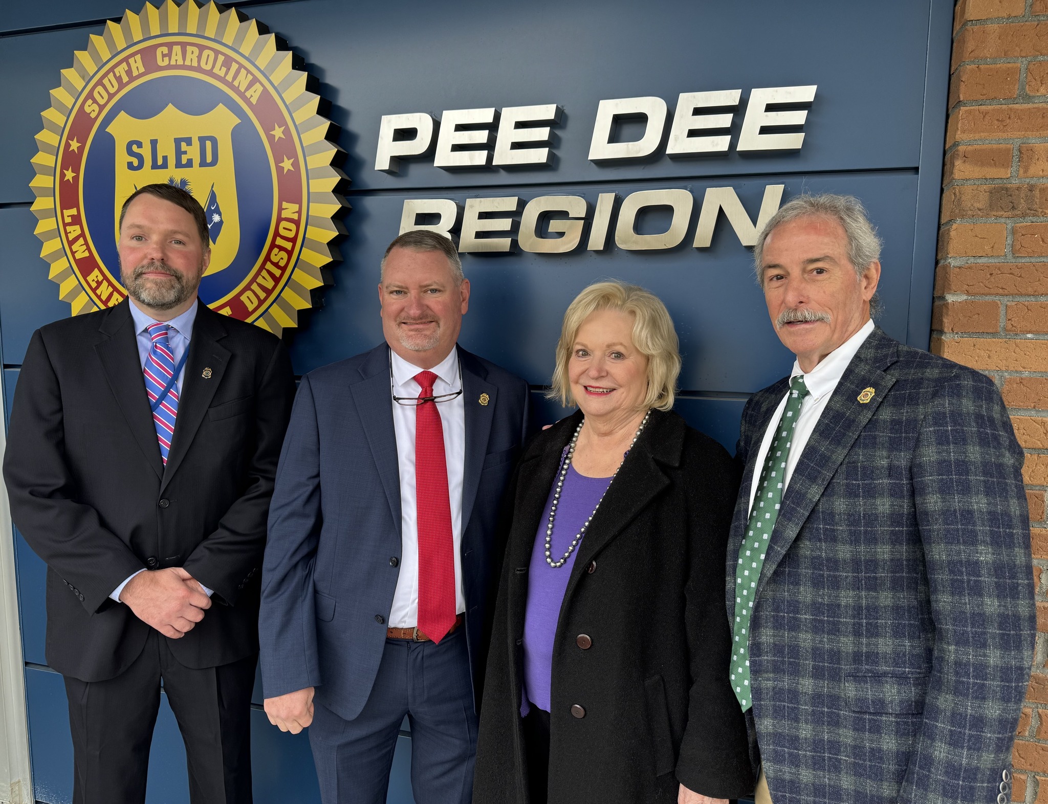 Pictured from left to right: SLED Pee Dee Regional Captain Glenn Wood, SLED Assistant Chief Richard Gregory, Mrs. Jean Leatherman – wife of the late South Carolina Senator Hugh Leatherman (R – District 31), and SLED Chief Mark Keel