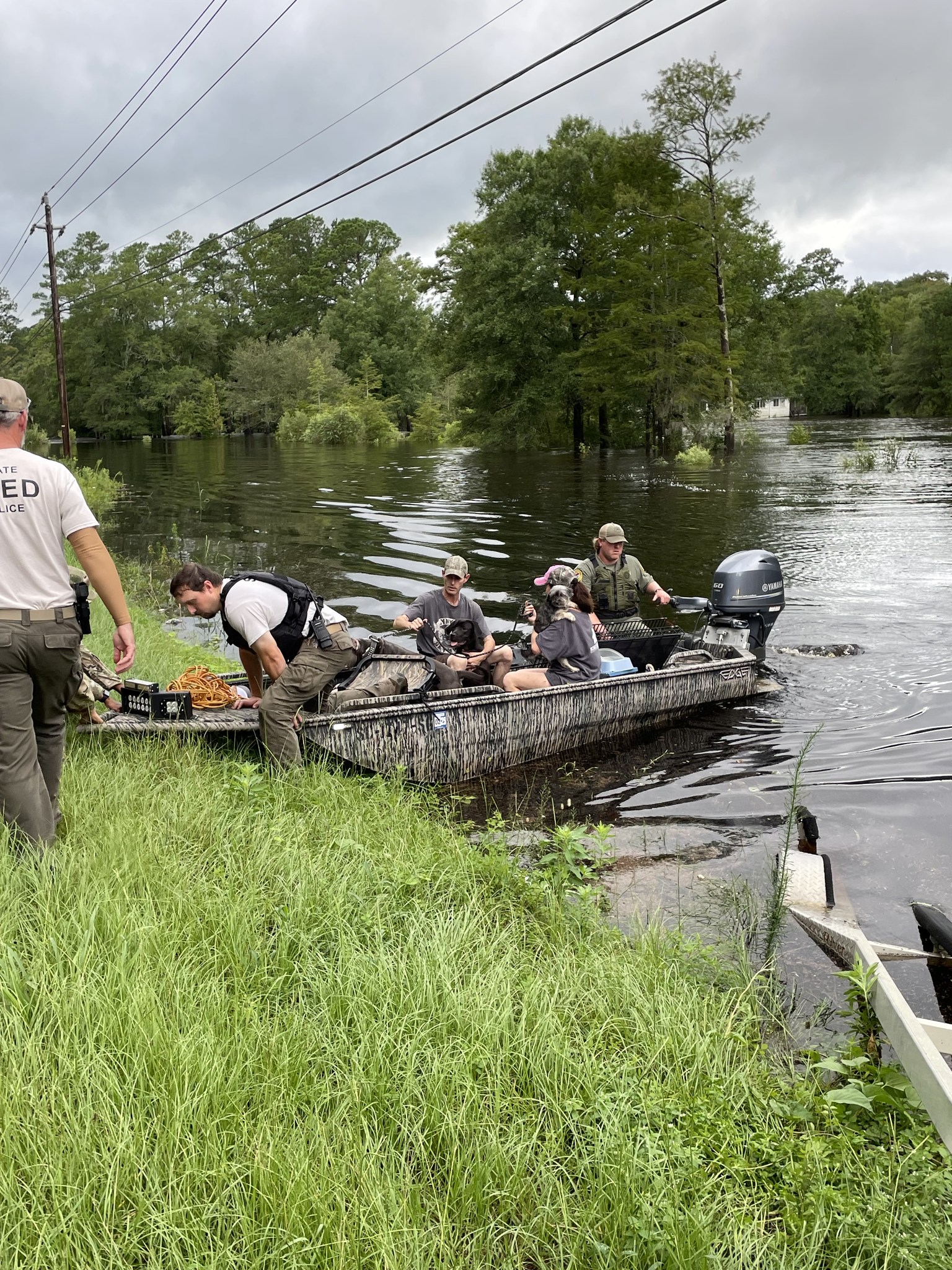 A boat full of people rescued coming on shore