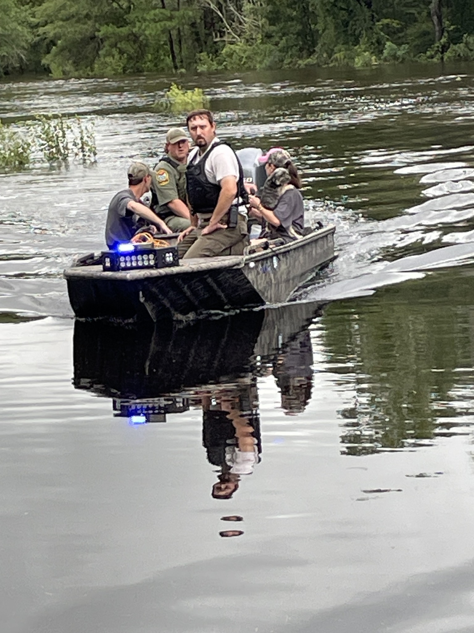People in a boat after being rescued from flood waters
